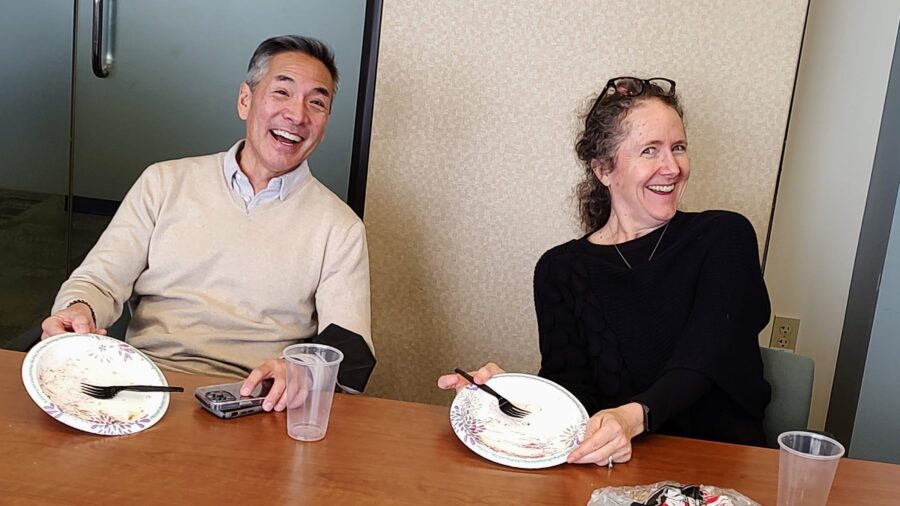 Jeff Sakuma and HSD co-worker Meg Woolf smile for the camera and show off empty plates during a Pi Day social gathering for staff.