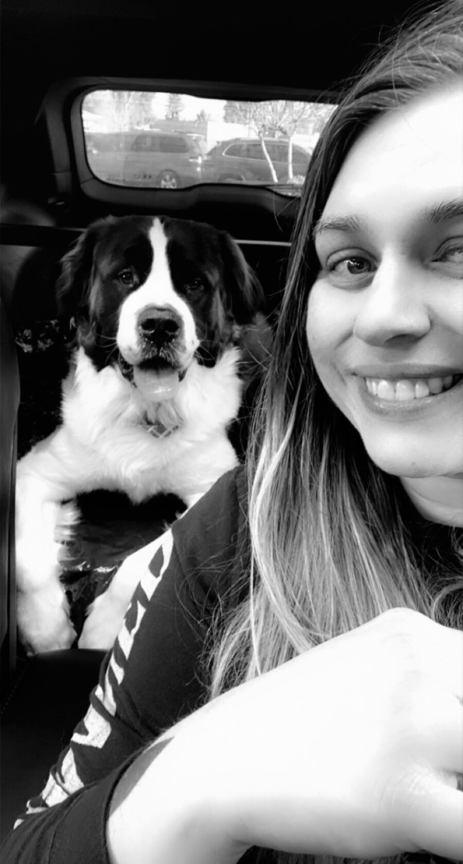 Black and White image of Tara Vallimont with her dog