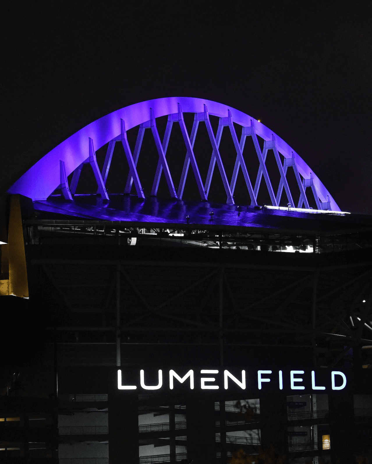 The arch lights at Lumen Field are lit up purple at night for Purple Thursday on October 20, 2022.