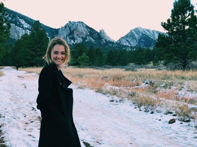 Photo of Hannah Whitworth in front of a mountain landscape